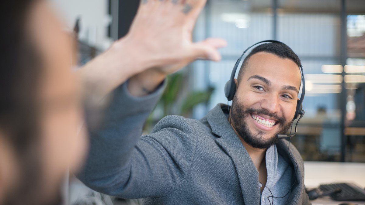 Happy employee celebrates his success with another colleague