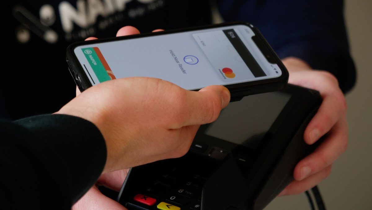 Transactional experience in motion as man tries to pay with app on smartphone