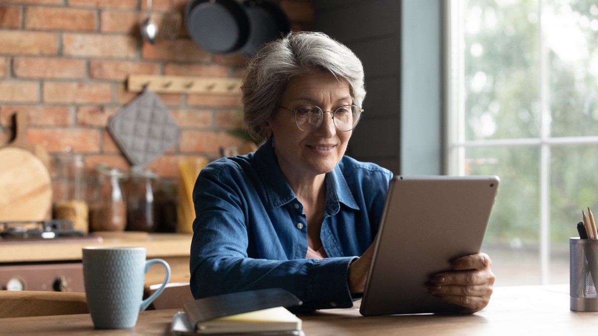 Older lady working through survey on her tablet