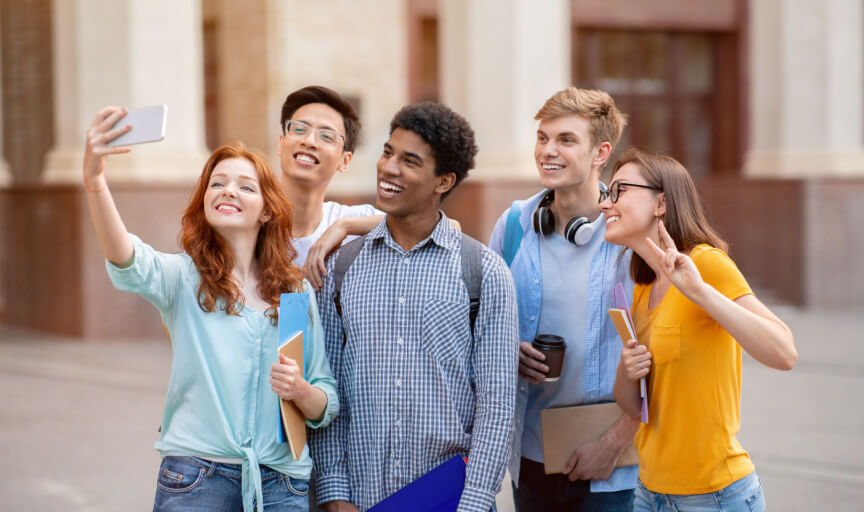 A group of students take a selfie as they leave at the end of their studies.