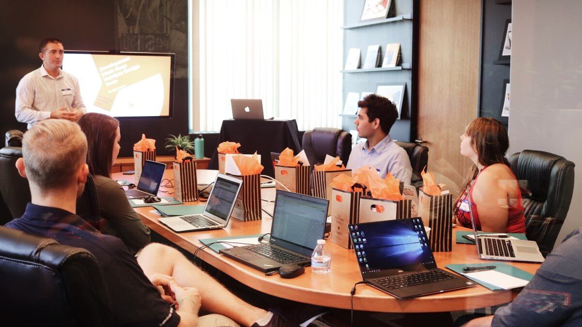 Employees give feedback during an office training session.