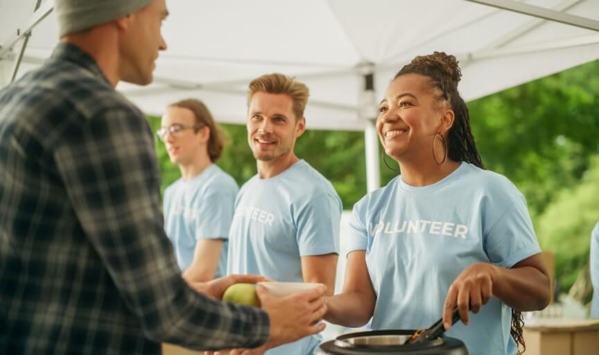 Volunteers work serving food at a pop-up humanitarian kitchen.